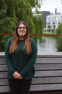 Photo of Beth Garrett, Student Governor, Vice President, Education of the University of Northampton Students’ Union, standing on the bridge outside of the Waterside Campus