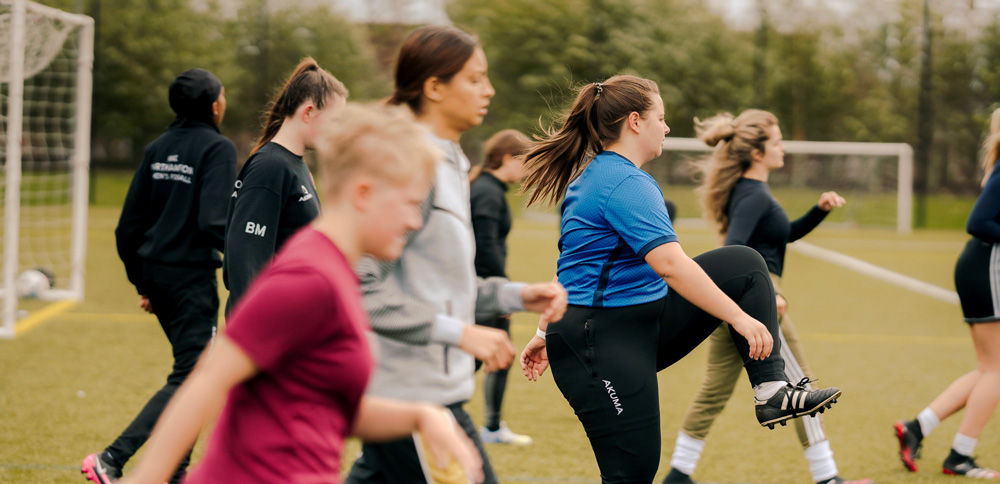 Students stretching on a playing field.