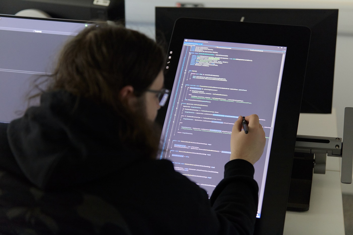 Student highlighting code on a computer screen