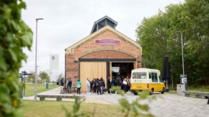 Students queue at an ice-cream van outside the Engine Shed building on campus at the University of Northampton. In the background is the tower of the University's Energy Centre