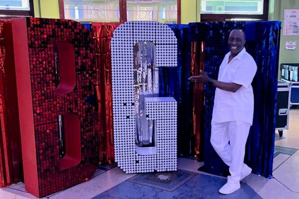 Ernie standing next to giant BGT letters.