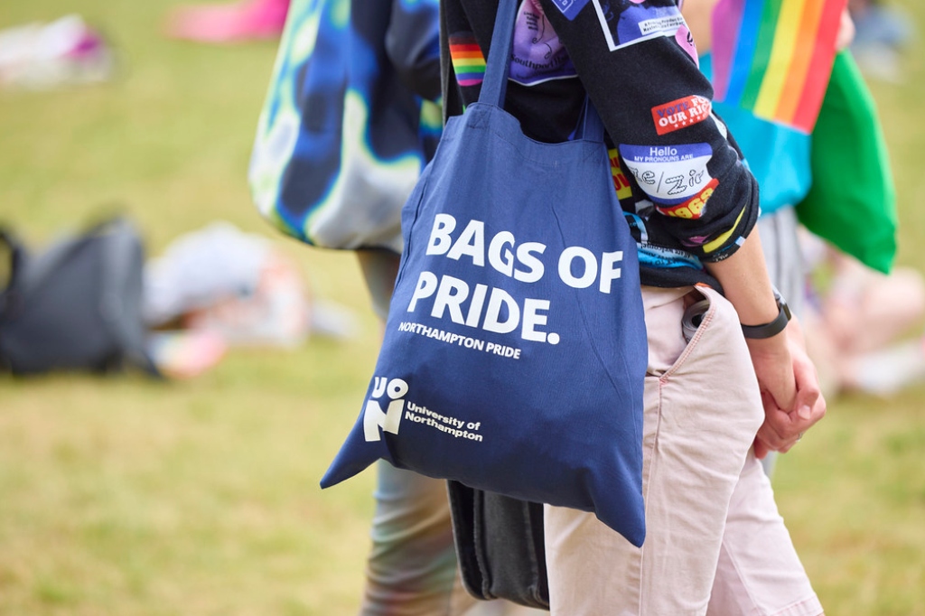 UON canvas bag on person's shoulder which reads 'Bags of Pride'.