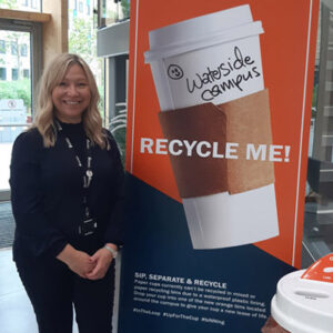 Emma Stone, Environment Adviser, standing next to a Recycle Me sign