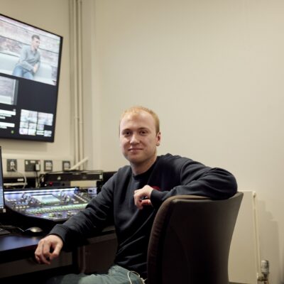 Student adjusts a standing lighting rig