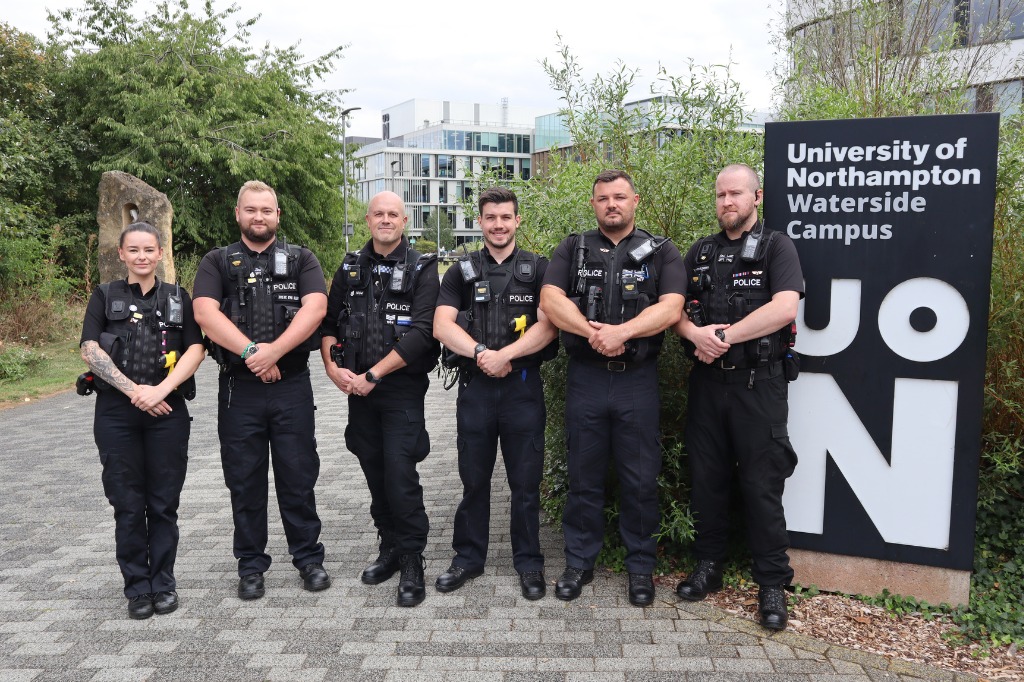 Group photo of UON Police Team stood next to UON campus sign.