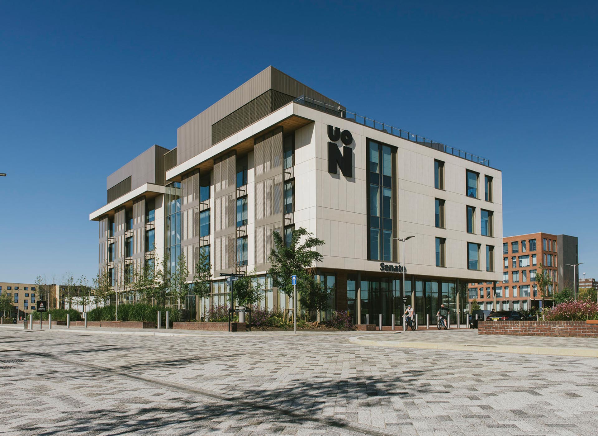 External view of Senate building at the University of Northampton, which is a modern building with cream features and grey roads surrounding it.