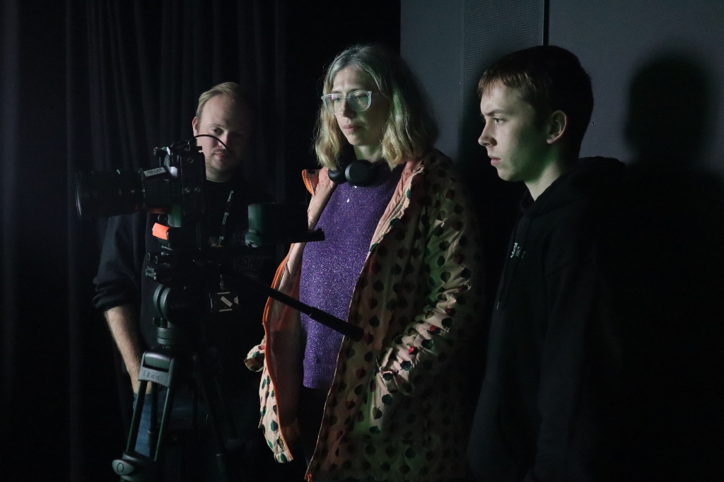 Group look into camera to review footage.