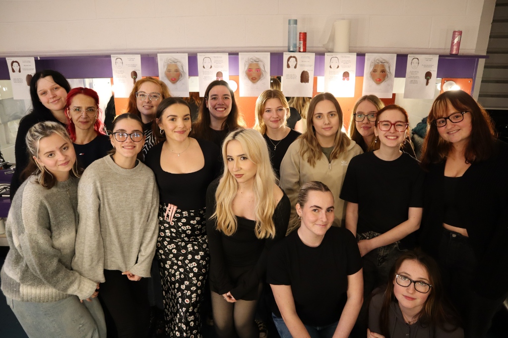 Group photo of Hair, Makeup and Prosthetics for Stage and Screen students smile at camera.