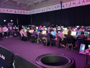 Esports students at EPIC LAN event. Students are sat at computers playing games.