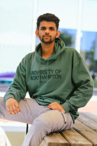 Muhammed Hafiz, sitting on a bench and looking at the camera.