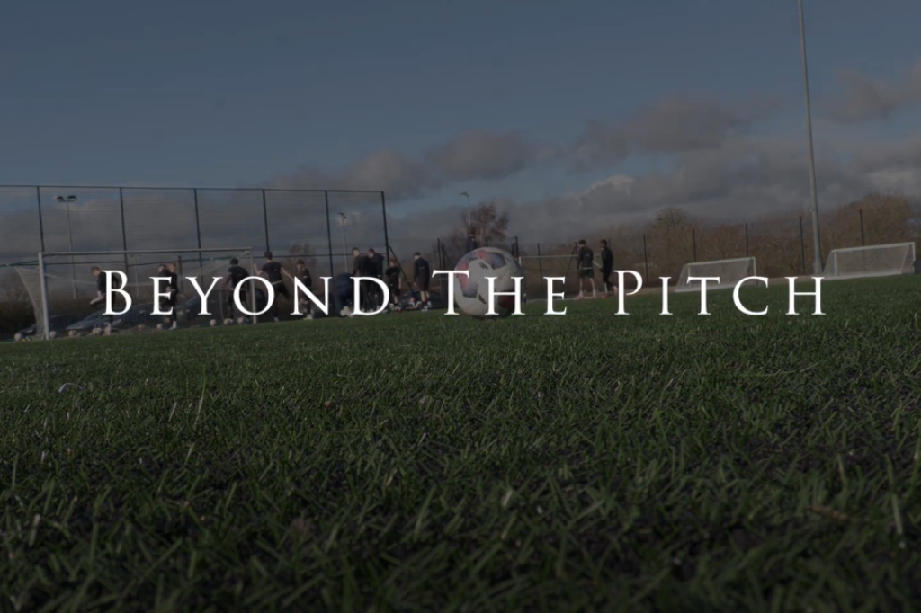 'Beyond the Pitch' title name in front of image of football pitch.