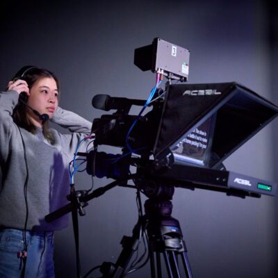 Student adjusts a standing lighting rig